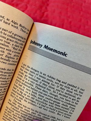 Opening page of the printed 'Johnny Mnemonic' by William Gibson, from a vintage paperback copy of the short story collection 'Burning Chrome.'