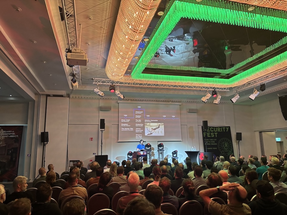 John on stage at Security Fest with part of the audience in the foreground.