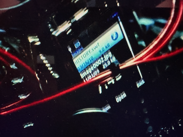 Photo from the movie showing the cellphone screen with the files and wires to the bomb around it.